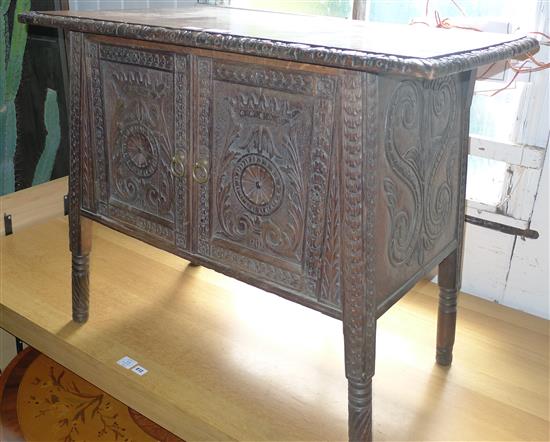 Carved oak low cupboard(-)